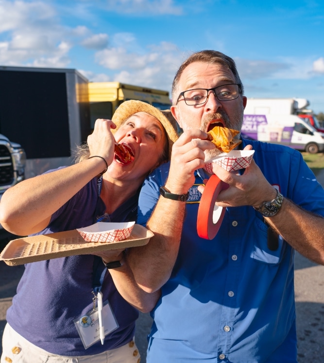 https://beignetfest.com/wp-content/uploads/2025/04/eating-beignets.jpg